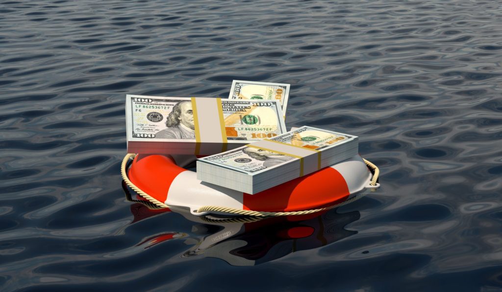 Lifesaver filled with money floating in the ocean.